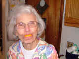 Old lady with lemon in her mouth